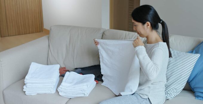 woman fold white towel at home 2021 08 29 05 19 52 utc 1 1