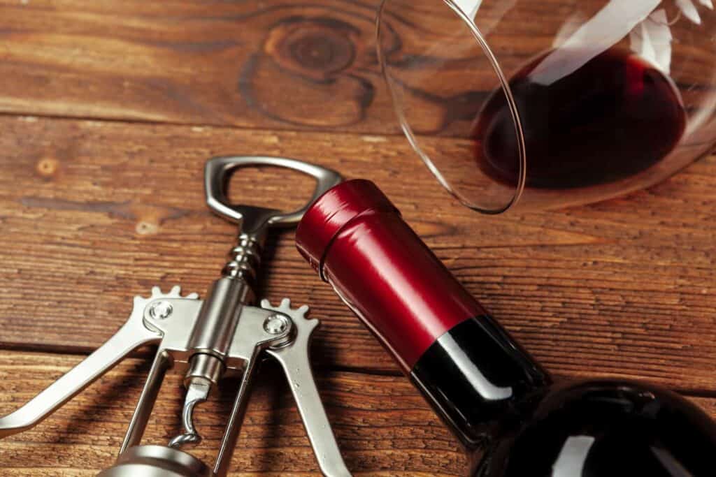 red wine bottle wine glass and corkscrew on woode 2022 01 06 16 05 02 utc 1 1