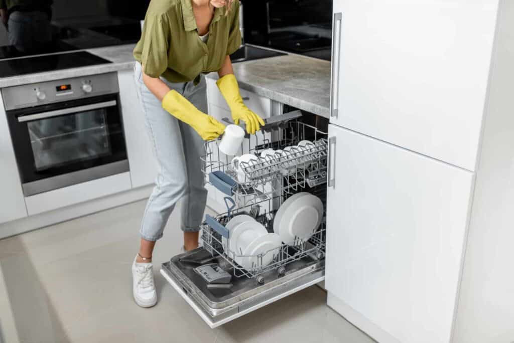 woman loading dishes into the dishwasher machine 2021 09 01 21 09 54 utc 1 1