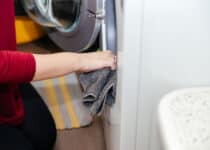 a woman cleans a washing machine regular clean up 2022 02 22 05 47 43 utc 1