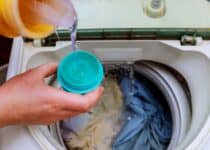 woman hand pouring washing powder into the washing 2021 09 04 10 21 46 utc 1 1