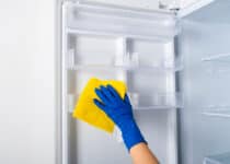 woman s hand in a glove washes the refrigerator 2021 10 21 02 28 54 utc 1