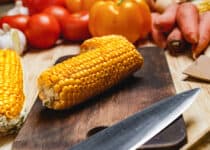 cobs of corn on wooden cutting board 2021 09 03 17 23 50 utc 1