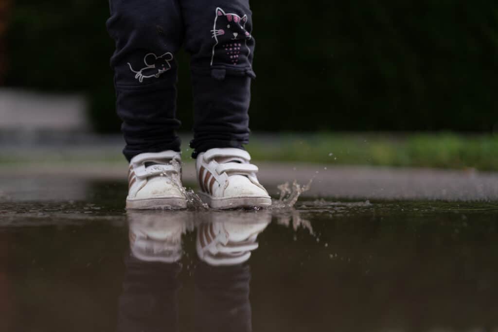little child standing with her sneakers in rain pu 2022 01 06 03 26 14 utc 1