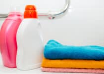 two bottles of laundry detergent and colorful towe 2022 02 22 05 48 02 utc 1
