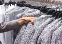 woman choices a wool coat on hangers in the store 2021 08 26 17 11 12 utc 1