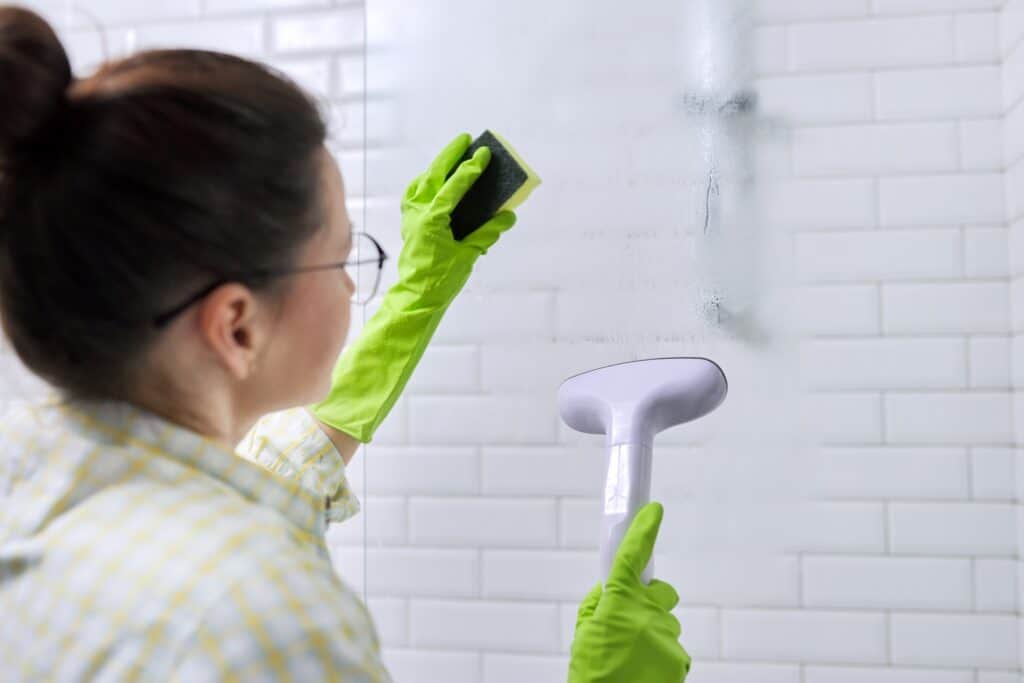 woman cleaning in bathroom washing glass with sho 2021 12 28 00 33 12 utc 2