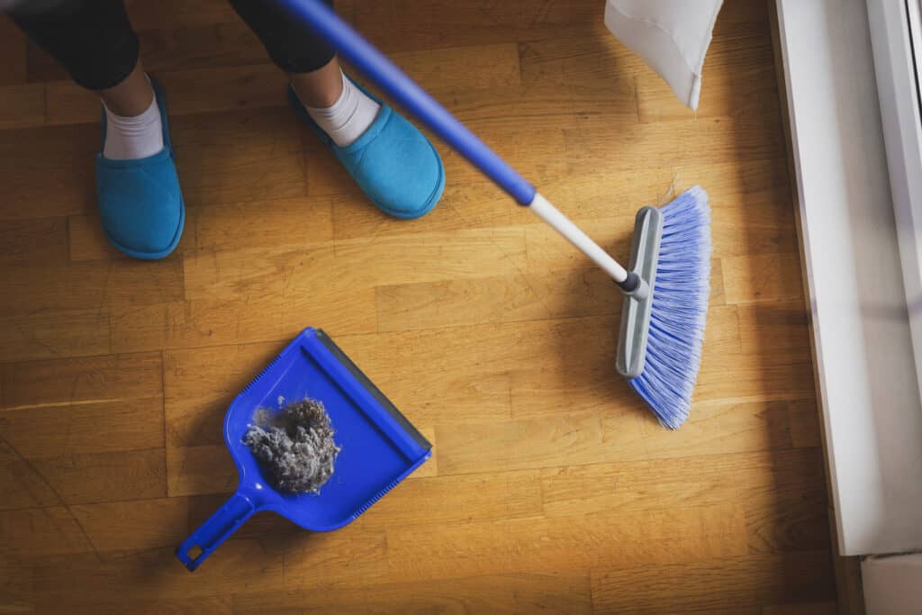 woman sweeping floor with a broom 2021 09 22 22 00 08 utc 1