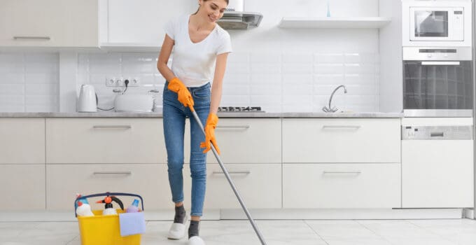 young brunette cleaning kitchen floor 2021 09 01 09 41 43 utc 1