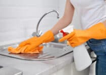 woman cleaning sink with rag and detergent in kitc 2021 09 01 09 41 43 utc 1