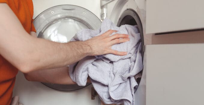 man loading color clothes and towels into built in 2022 02 07 11 49 25 utc 1 1