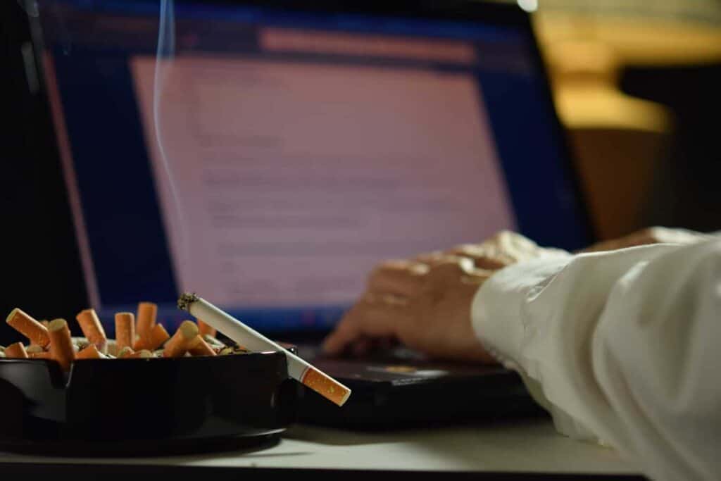 man working on laptop computer with lit and smokin 2021 08 26 20 10 07 utc 1 1