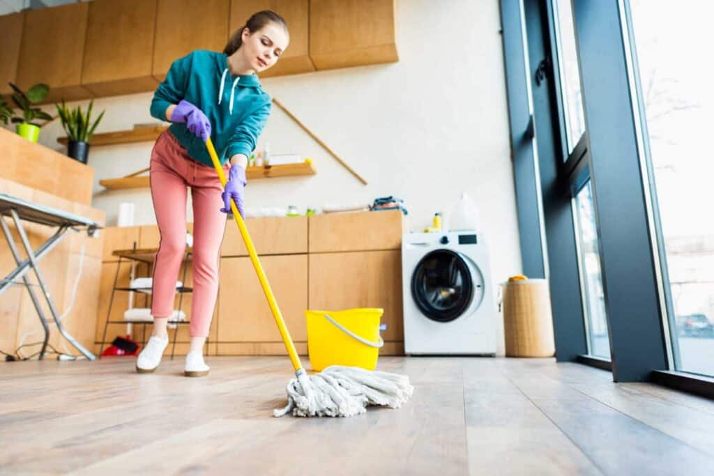 low angle view of young woman cleaning home with m 2021 08 29 19 38 22 utc 1 1