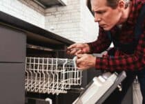 repairing dishwasher male technician sitting near 2021 09 03 20 52 48 utc 1 1