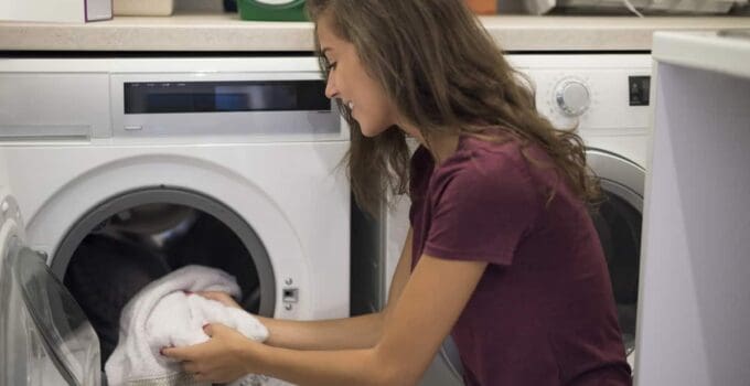 woman turning on a washing machine 2021 08 26 20 15 54 utc 1 1