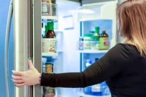 woman looking in open refrigerator 2021 09 01 15 06 03 utc 1 1