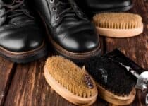 black boots on wooden background with polishing eq 2021 08 26 17 16 16 utc