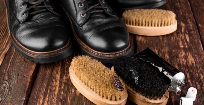 black boots on wooden background with polishing eq 2021 08 26 17 16 16 utc